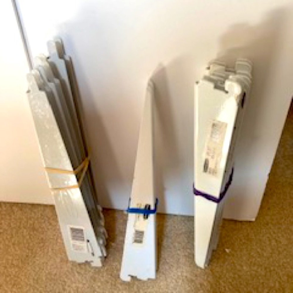 Assorted white Rubbermaid shelf brackets.
SOLD